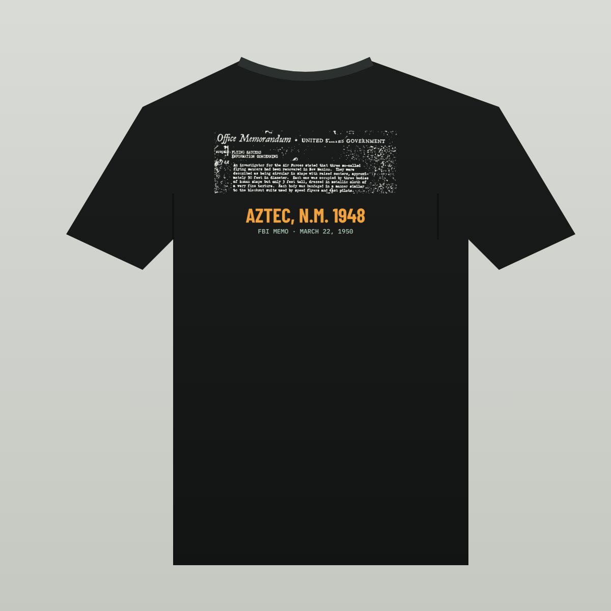 Black tee with the scanned 1950 FBI memo printed in white, header, Flying Saucers subject line and the paragraph about three saucers, over AZTEC, N.M. 1948 in orange