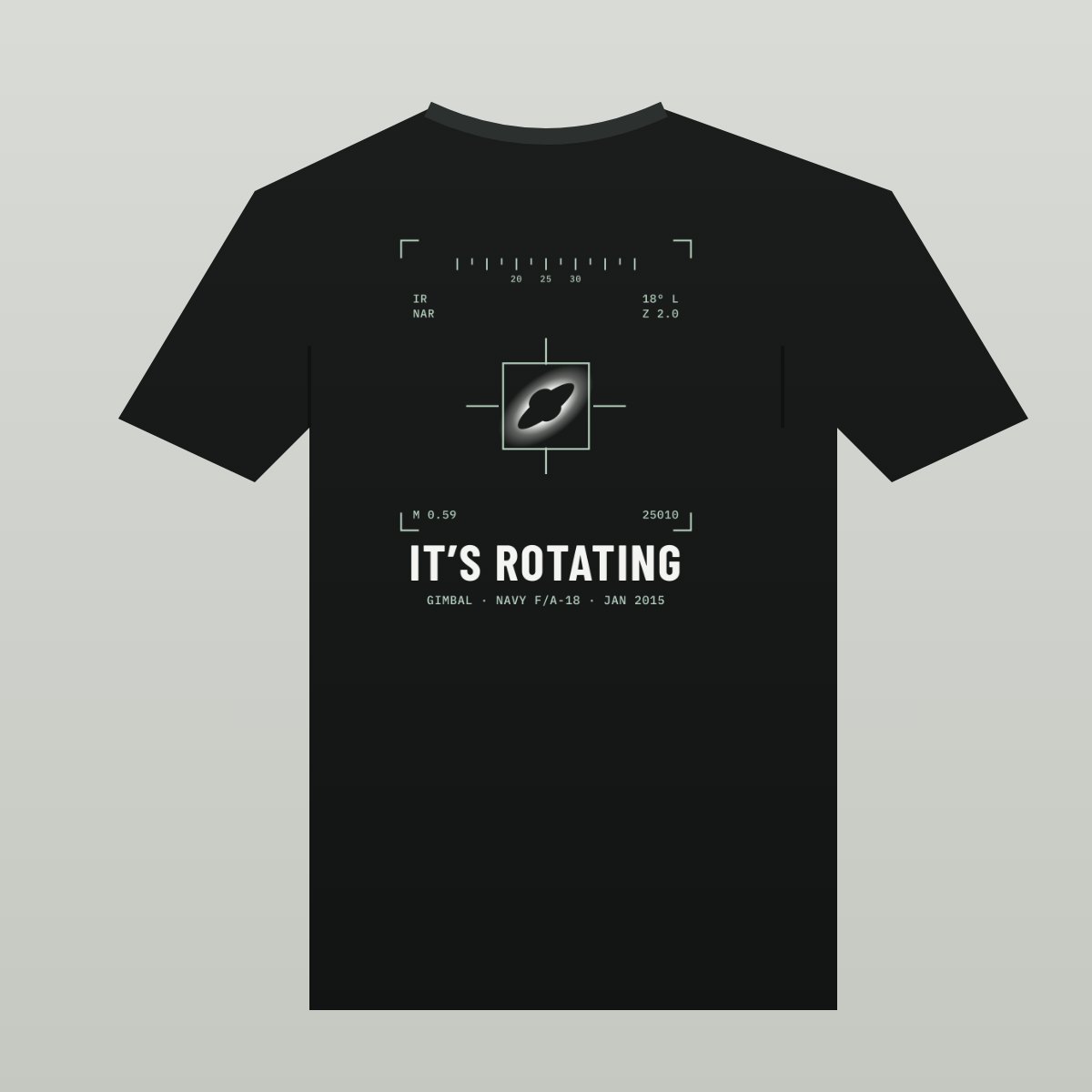Black tee with a targeting screen: a dark tilted shape with a bright glow inside a box, crosshairs and readouts, over the words IT'S ROTATING
